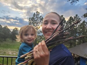Dr. Rachel Langley and her child working on her personal homestead.